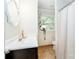 Well-lit bathroom featuring a white vanity and decorative mirror with a window view at 10743 Ola Dr, Indian Land, SC 29707