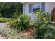 Landscaped yard featuring vibrant sunflowers and a variety of blossoming plants by the house at 10743 Ola Dr, Indian Land, SC 29707