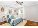 This main bedroom features natural light, decor, hardwood floors, and an ensuite bathroom for added comfort at 10743 Ola Dr, Indian Land, SC 29707
