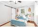 This main bedroom features natural light, decor, hardwood floors, and an ensuite bathroom for added comfort at 10743 Ola Dr, Indian Land, SC 29707