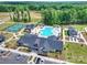 Aerial view of community pool, clubhouse, and tennis courts amidst lush greenery at 1133 Idyllic Ln, Waxhaw, NC 28173