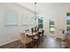 Bright dining area featuring a modern chandelier and views of the outdoor area at 1133 Idyllic Ln, Waxhaw, NC 28173