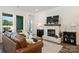 Inviting living room with a fireplace, comfortable sofas, hardwood floors, and plenty of natural light at 1133 Idyllic Ln, Waxhaw, NC 28173