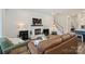 Bright living room featuring a fireplace, comfortable seating, hardwood floors, and a staircase leading upstairs at 1133 Idyllic Ln, Waxhaw, NC 28173
