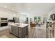 Spacious open-concept living room featuring kitchen island, dining area, and a comfortable seating arrangement at 1133 Idyllic Ln, Waxhaw, NC 28173