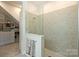 Modern walk-in shower, adjacent to a custom closet, provides convenience and style at 1133 Idyllic Ln, Waxhaw, NC 28173