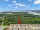 Aerial view features a row of townhomes, lush greenery, and a glimpse of the tranquil lake at 117 Lanyard Dr # E, Mooresville, NC 28117