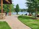 Beautiful lakeside property with lush lawn, stone patio, and scenic water views at 117 Lanyard Dr # E, Mooresville, NC 28117