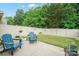 Inviting backyard features a patio with stylish blue Adirondack chairs and a well-manicured lawn at 117 Lanyard Dr # E, Mooresville, NC 28117