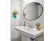 Modern bathroom features a round mirror, vessel sink, and decorative accents at 117 Lanyard Dr # E, Mooresville, NC 28117