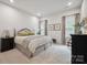 Bright bedroom features neutral tones, plush bedding, and ample natural light at 117 Lanyard Dr # E, Mooresville, NC 28117