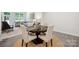 Bright dining area with a round table and chairs, complemented by a stylish living room with modern decor at 117 Lanyard Dr # E, Mooresville, NC 28117
