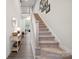 Inviting entryway featuring a staircase, console table, and decor, leading to the living spaces upstairs at 117 Lanyard Dr # E, Mooresville, NC 28117