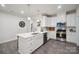 Modern kitchen featuring white cabinets, stainless steel appliances, a central island, and hardwood floors at 117 Lanyard Dr # E, Mooresville, NC 28117