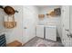 Bright laundry room features front load washer/dryer, decor, and built in storage space at 117 Lanyard Dr # E, Mooresville, NC 28117
