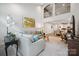 Open-concept living room boasts soaring ceilings, modern decor, and abundant natural light at 117 Lanyard Dr # E, Mooresville, NC 28117