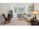 Bright living room boasts large windows, plush seating, and a calming color palette at 117 Lanyard Dr # E, Mooresville, NC 28117