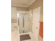 This bathroom has a tiled shower with glass doors, a soaking tub and door to the hallway at 1253 Iverleigh Trl, Charlotte, NC 28270