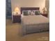 Bedroom features a comfortable bed, dark wooden furniture, and neutral tones throughout at 1253 Iverleigh Trl, Charlotte, NC 28270
