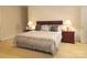 Cozy bedroom featuring a queen-size bed, nightstands, and warm lighting at 1253 Iverleigh Trl, Charlotte, NC 28270