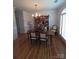 Formal dining room with hardwood floors, ornate chandelier and large windows offering natural light at 1253 Iverleigh Trl, Charlotte, NC 28270