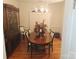 Formal dining room featuring a chandelier, plantation shutters, and hardwood floors at 1253 Iverleigh Trl, Charlotte, NC 28270