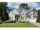 Charming home featuring a stone facade, arched entryway, manicured landscaping, and a two-car garage at 1253 Iverleigh Trl, Charlotte, NC 28270