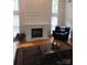 Bright living room with hardwood floors, a fireplace, and a black chair at 1253 Iverleigh Trl, Charlotte, NC 28270