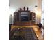 Spacious living room featuring hardwood floors, large windows, and a decorative entertainment center at 1253 Iverleigh Trl, Charlotte, NC 28270