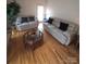 Bright living room with hardwood floors and neutral-toned sofas; perfect for relaxing or entertaining guests at 1253 Iverleigh Trl, Charlotte, NC 28270