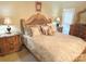 Well-lit primary bedroom features an upholstered headboard, a chest of drawers, and bedside tables at 1253 Iverleigh Trl, Charlotte, NC 28270