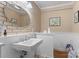 Bathroom with brick accent wall, single sink, and white paneled lower walls at 1315 Cortland E Rd, Charlotte, NC 28209