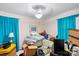 Bedroom featuring ceiling fan, curtains, table lamp, and discarded boxes at 1315 Cortland E Rd, Charlotte, NC 28209