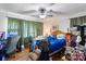 Bedroom featuring wood floors, ceiling fan, wooden bed frame, and a desk at 1315 Cortland E Rd, Charlotte, NC 28209