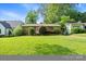 Quaint brick house featuring a lush green lawn and a well-kept garden at 1315 Cortland E Rd, Charlotte, NC 28209