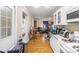 Bright and open kitchen with white cabinetry, hardwood floors, and modern appliances at 1315 Cortland E Rd, Charlotte, NC 28209
