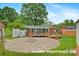 Spacious backyard with a stone firepit area, wooden deck and seating, perfect for outdoor gatherings and relaxation at 1405 8Th Nw Ave, Conover, NC 28613