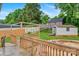 Well-maintained backyard featuring a wooden deck with railing, storage sheds, and landscaped areas for outdoor enjoyment at 1405 8Th Nw Ave, Conover, NC 28613