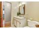 Well-lit bathroom featuring a vanity with sink, framed mirror and toilet, creating a cozy and functional space at 1405 8Th Nw Ave, Conover, NC 28613