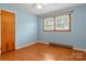 Bright bedroom featuring hardwood floors, fresh paint, and natural light through the window at 1405 8Th Nw Ave, Conover, NC 28613