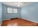 Bright bedroom featuring hardwood floors, fresh paint, and natural light through the window at 1405 8Th Nw Ave, Conover, NC 28613