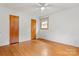 Bedroom featuring hardwood flooring, white walls, two closets for storage, and a ceiling fan at 1405 8Th Nw Ave, Conover, NC 28613