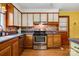 Traditional kitchen features wood cabinets, stainless steel appliances, and mosaic tile backsplash at 1405 8Th Nw Ave, Conover, NC 28613