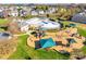 Aerial view highlights the community pool, playground, and surrounding green spaces, perfect for recreation at 1412 Afternoon Sun Rd, Matthews, NC 28104