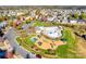 Aerial view showcases community pool, playground, and neatly arranged homes surrounded by autumn foliage at 1412 Afternoon Sun Rd, Matthews, NC 28104