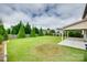 A large backyard with green grass and a covered patio offers an outdoor living space at 1412 Afternoon Sun Rd, Matthews, NC 28104