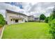 Expansive backyard featuring a lush green lawn and a covered patio, perfect for outdoor activities at 1412 Afternoon Sun Rd, Matthews, NC 28104