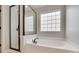 Bathroom featuring a white soaking tub next to glass enclosed shower at 1412 Afternoon Sun Rd, Matthews, NC 28104