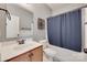 Full bathroom featuring a single sink vanity, decorative mirror, and shower with blue curtain at 1412 Afternoon Sun Rd, Matthews, NC 28104
