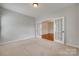 Carpeted room with French doors leading to a dining room with hardwood floors at 1412 Afternoon Sun Rd, Matthews, NC 28104